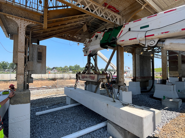 Precast beams (13,000–20,000 lbs) precisely placed under the canopy.